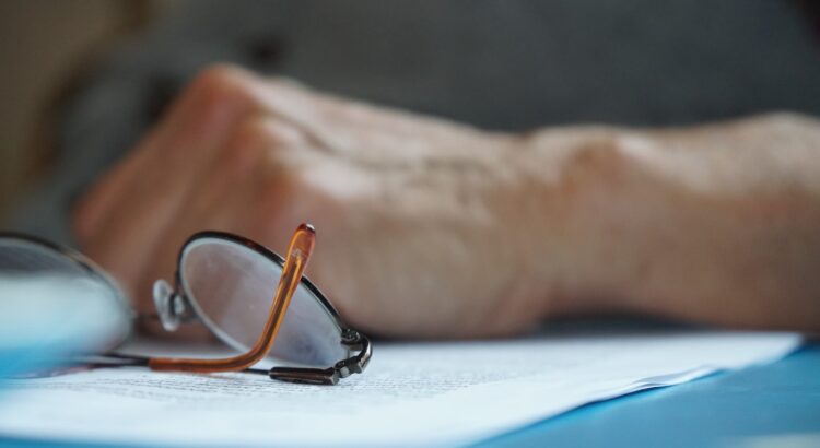 brown framed eyeglasses on blue textile