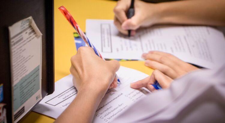 person writing on white paper